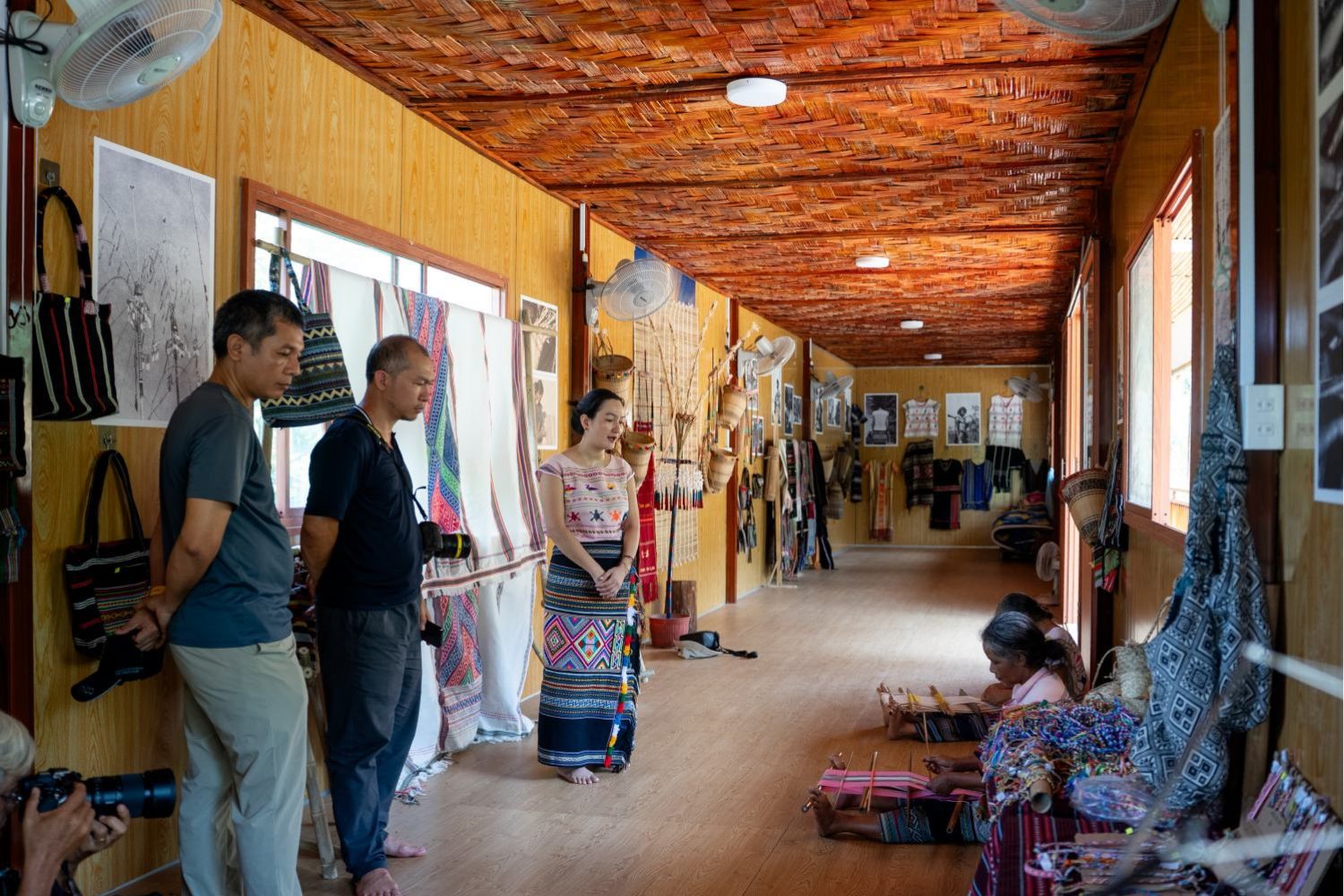 Visitors learn from Ms. Ka Huong about traditional Ma weaving techniques as part of a Katien Safari tour experience.